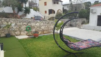 a chair in a yard with a rock wall at γαληνη in Vamos