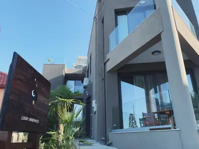 a building with a sign in front of it at King Crimson Luxury Apartments in Marathokefála