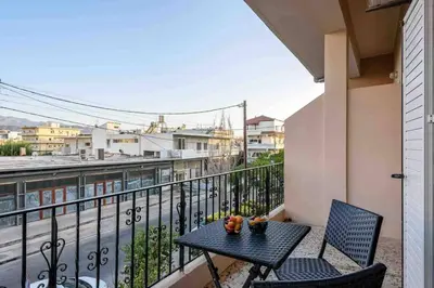 a table and chairs on a balcony with a view at EMMANUEL’S COZY HOUSE in Chania Town