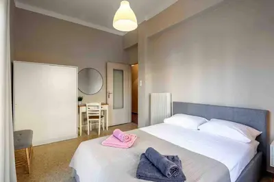 a bedroom with a bed with two towels on it at EMMANUEL’S COZY HOUSE in Chania Town