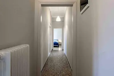a hallway with white walls and a hallway with a radiator at EMMANUEL’S COZY HOUSE in Chania Town