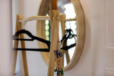a mirror on a wall with a wooden stick at Villa Seashell -Wonderful newly renovated villa on the beach in Galatás