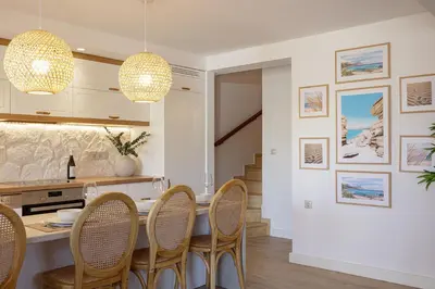 a kitchen with a dining table and chairs at Villa Seashell -Wonderful newly renovated villa on the beach in Galatás