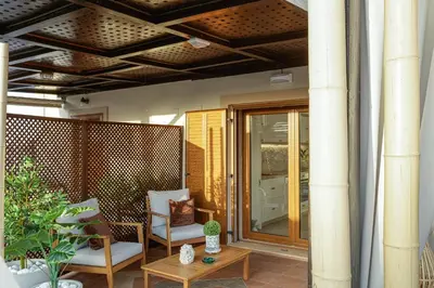 a patio with two chairs and a table at Villa Seashell -Wonderful newly renovated villa on the beach in Galatás