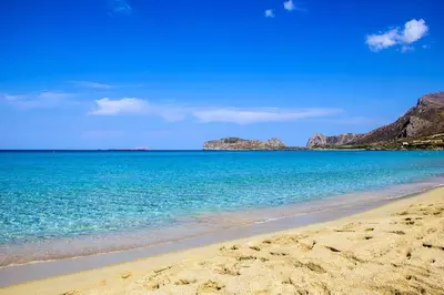 a beach with blue water and mountains in the background at Kampos View - Quiet House at the end of the Road, private pool in Kámbos