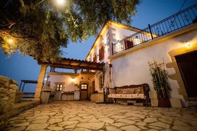 a building with a bench in front of it at Villa Tzitzifes in Tzitzifés