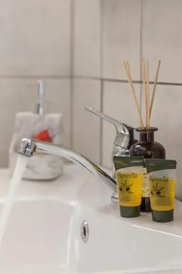 a bathroom sink with a toothbrush holder and a bottle of tooth paste at kissamos seaside bliss in Kissamos