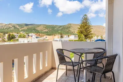 a table and chairs on a balcony with a view at kissamos seaside bliss in Kissamos