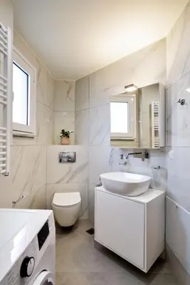 a white bathroom with a sink and a toilet at Elia Residences in Chania Town