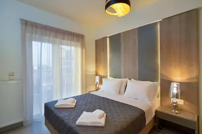 a bedroom with a bed with two towels on it at Elia Residences in Chania Town