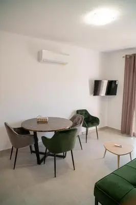 a living room with a table and chairs at Hello Village Chania in SFakianalíon