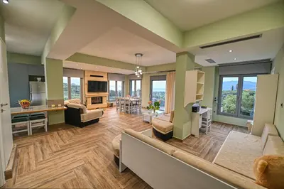 a large living room with a couch and a kitchen at Anemomili Villas in Drapaniás