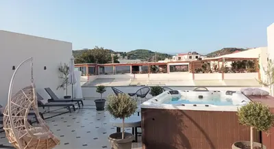 a patio with a hot tub on a roof at Elia Platanias in Plataniás