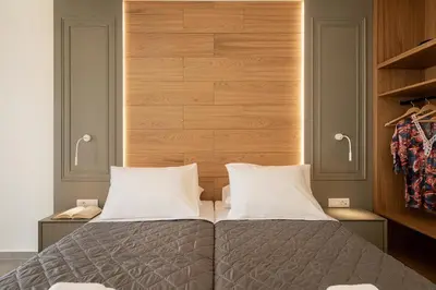a bedroom with a bed with two pillows at Elia Platanias in Plataniás