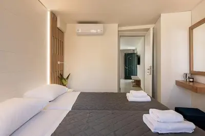 a bedroom with a bed with two towels on it at Elia Platanias in Plataniás
