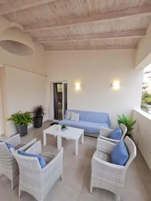 a living room with a blue couch and chairs at Marika's Penthouse Chania in Chania Town