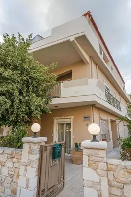 a house with a gate and a fence at Marika's Penthouse Chania in Chania Town