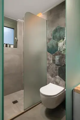 a bathroom with a toilet and a shower at Villas Plumeria in Palaiochóra