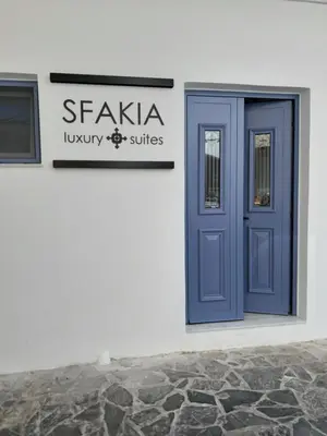 a blue door on the side of a building at Sfakia Seaside luxury Suites in Khóra Sfakíon