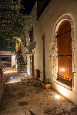 an entrance to a building with a wooden door at STAMATOGIANNIS Traditional Apartments in Kalivianí