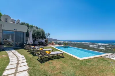 a villa with a swimming pool with a view of the ocean at Villa Maritini in Chania Town