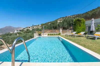 a swimming pool in a yard with a house at Villa Maritini in Chania Town