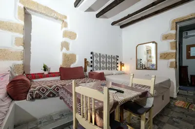 a kitchen and dining room with a table and chairs at Vryses Crete-Village Vibes in Vryses