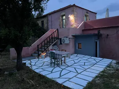 a patio with a table in front of a house at Vryses Crete-Village Vibes in Vryses