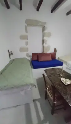 a small room with a bed and a table at Vryses Crete-Village Vibes in Vryses