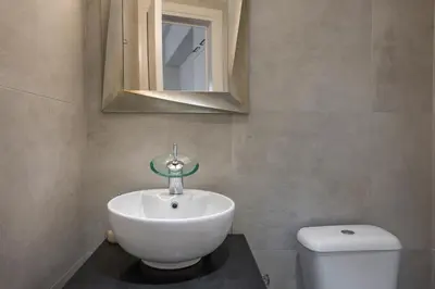 a bathroom with a sink and a toilet at Ethyr City Living in Chania Town