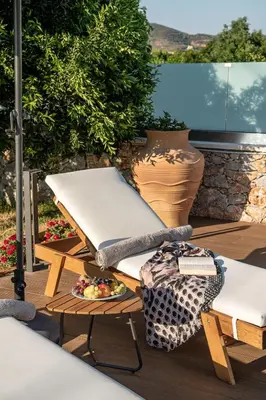 a table and chairs sitting on a deck with a plate of food at Villa Enny, 3 BD with Private Heated Pool in Ayiá