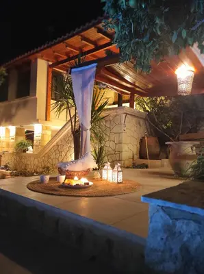a vase sitting on top of a table with lights at Villa Anthemida Chania in Ayiá