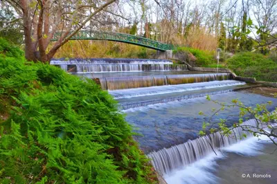 a small waterfall with a green bridge over it at Villa Anthemida Chania in Ayiá