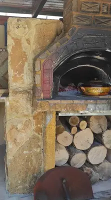a stone oven with a bowl on top of it at Villa Anthemida Chania in Ayiá