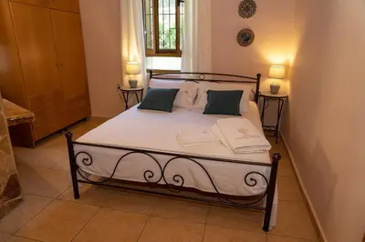 a bedroom with a bed with two pillows on it at Villa Anthemida Chania in Ayiá
