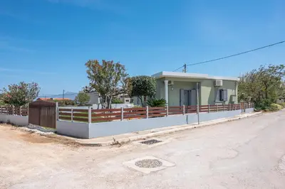 a house with a fence on the side of a road at Lahardi - Seaside House in Kissamos