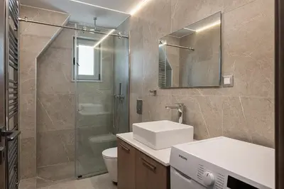 a bathroom with a shower and a sink and a toilet at Kappa Residence in Chania Town