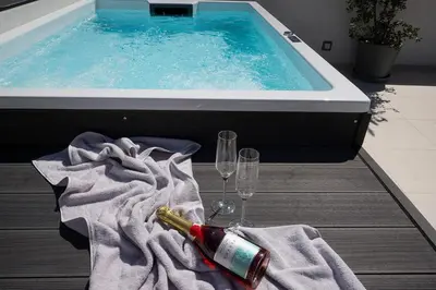 a swimming pool with two glasses and a bottle of champagne at Kappa Residence in Chania Town