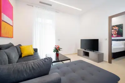 a living room with a couch and a television at Kappa Residence in Chania Town