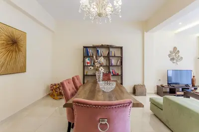 a dining room with a table and chairs and a chandelier at ΠΑΡΑΘΑΛΑΣΣΙΟ in Ayiá
