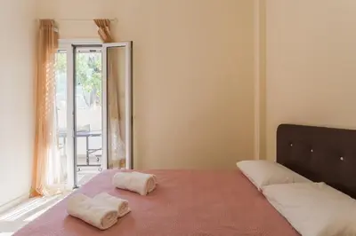 a bedroom with a bed with two towels on it at ΠΑΡΑΘΑΛΑΣΣΙΟ in Ayiá