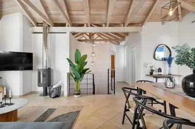 a living room with a dining room table and chairs at Villa Hemera ocean view private heated pool in Chorafakia