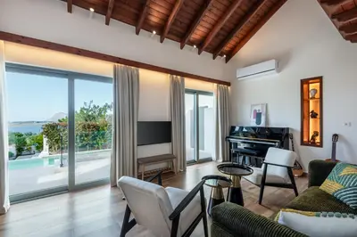 a living room with a couch and a piano at SeaView villa with piano by Chania Living Stories in Chania Town