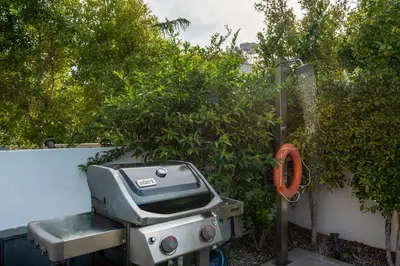 a barbecue grill sitting next to a bush at SeaView villa with piano by Chania Living Stories in Chania Town