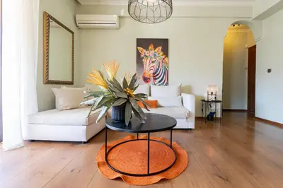 a living room with a table and a couch at Chania dream apartment in Chania Town