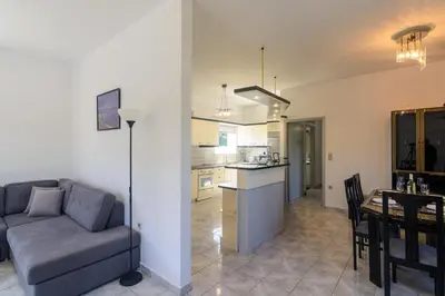 a living room and kitchen with a couch and a table at Anastasia Home in Palaiochóra