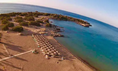 an island with a bunch of chairs on the beach at Anastasia Home in Palaiochóra