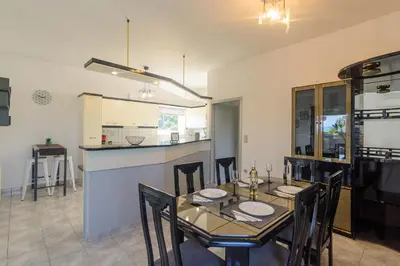 a dining room and kitchen with a table and chairs at Anastasia Home in Palaiochóra