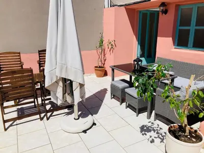a patio with an umbrella and a table and chairs at Casa Mersini in Chania Town