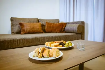 two plates of food on a table in a living room at ANTEL Suites & Apartments in Chania Town